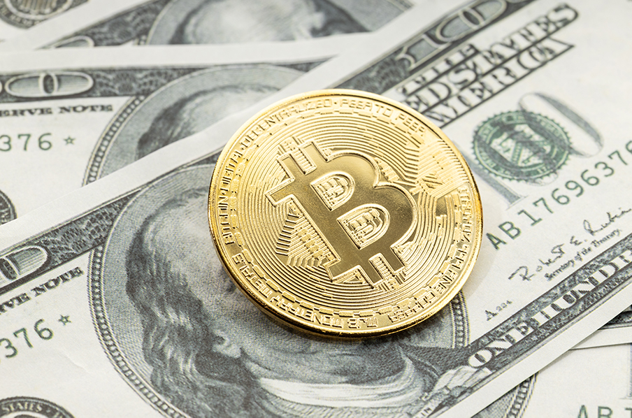bitcoin-coin-on-dollar-banknotes